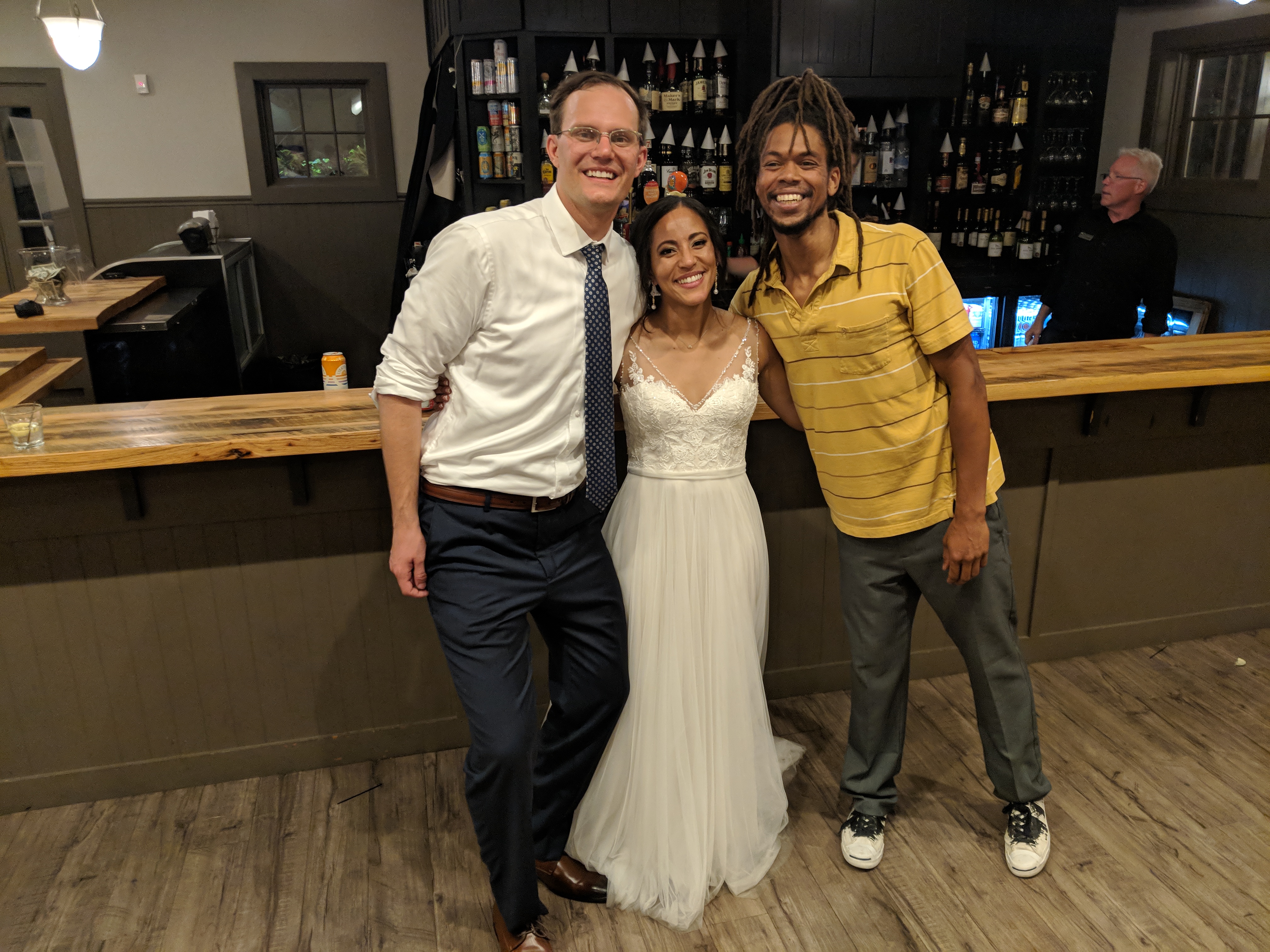 Nick May with wedding couple at reception venue
