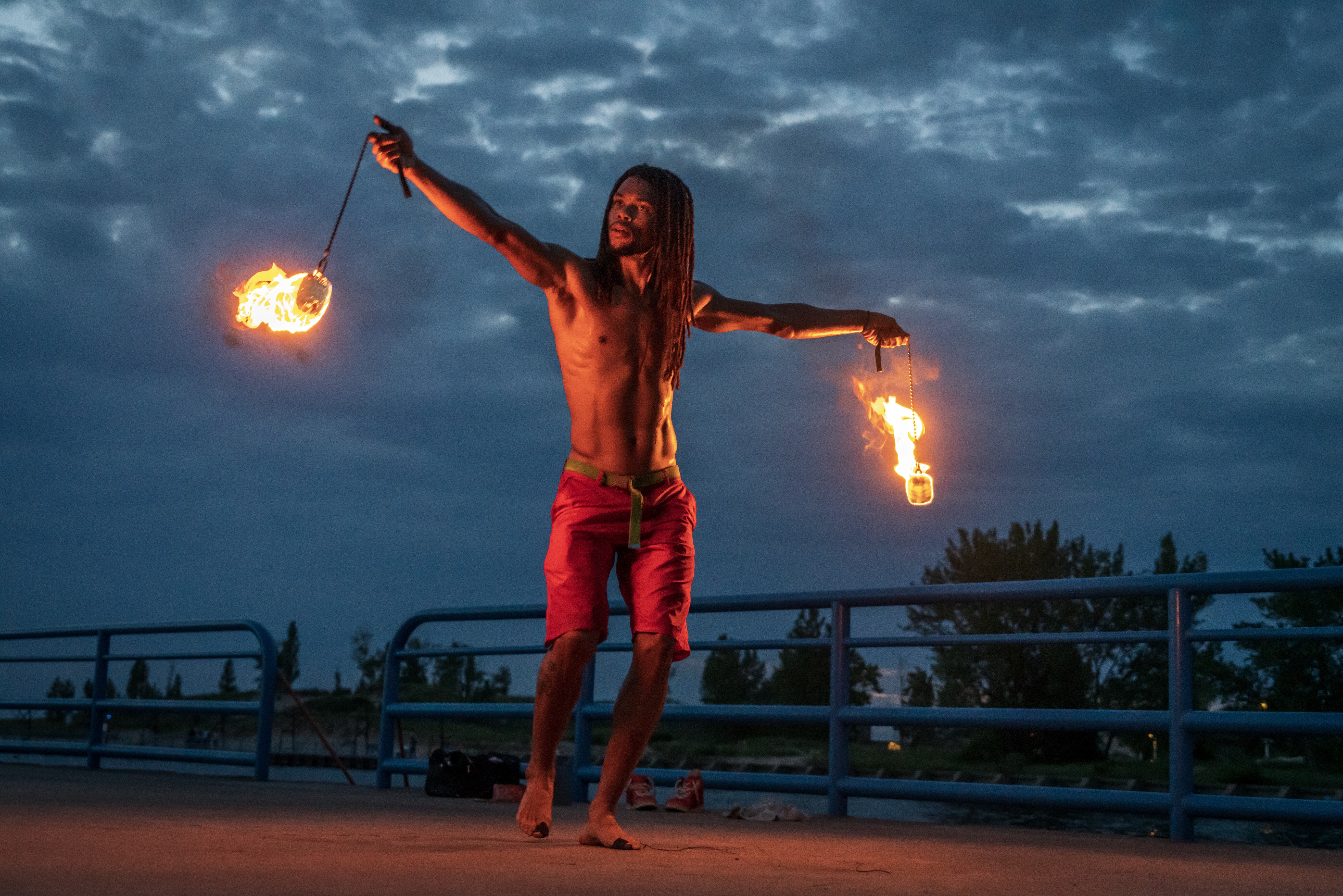 Nick May fire poi performance at dusk
